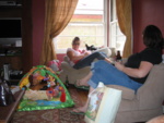 Daisy on the floor, Erin is holding Ruby and Delilah the chihauhua is keeping watch.
